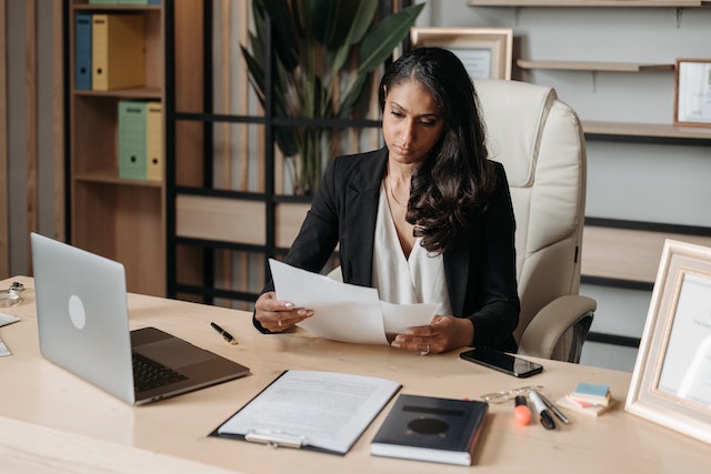 a professional at a desk looking through papers